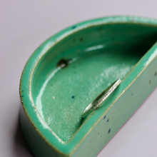 Lined Textured Stacker Ring on green dish