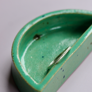 Lined Textured Stacker Ring on green dish